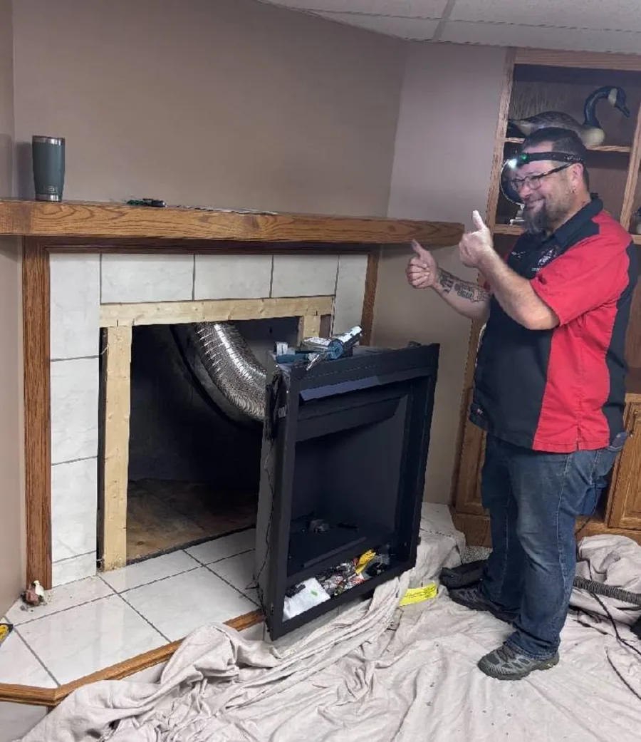 Aviation Mechanical technician fitting a gas fireplace insert
