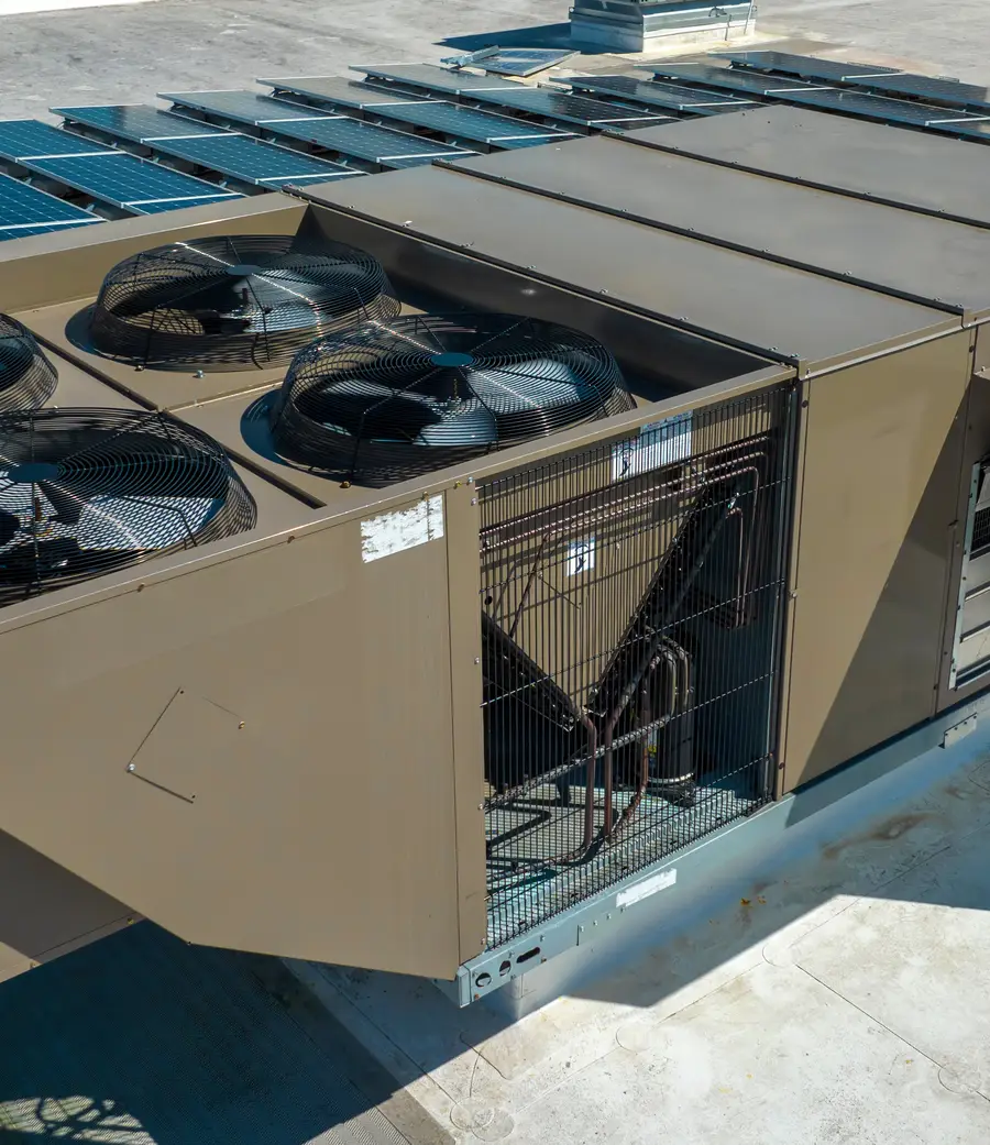 Packaged rooftop unit on a commercial roof with its service panels open