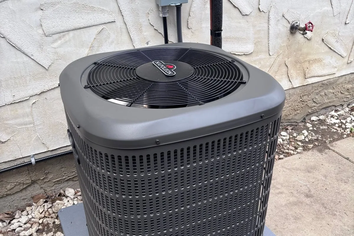 Outdoor condensing unit installed beside a home