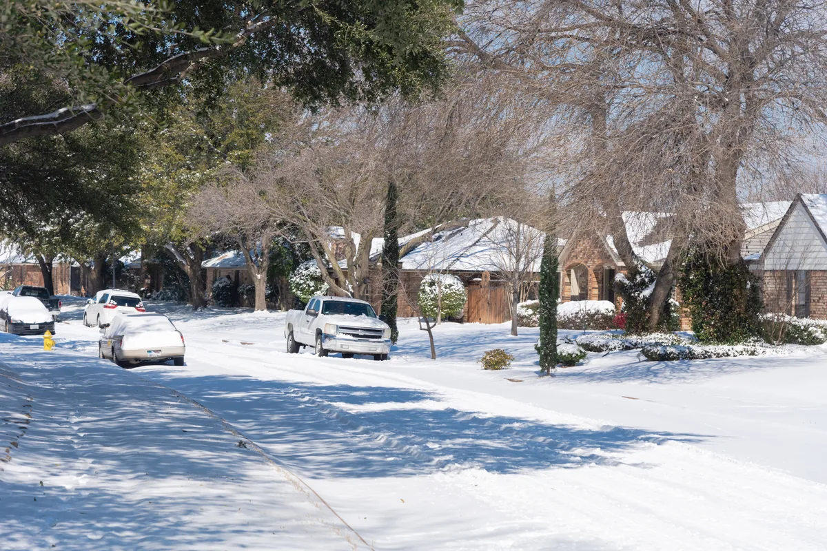 A snow-covered residential street in winter