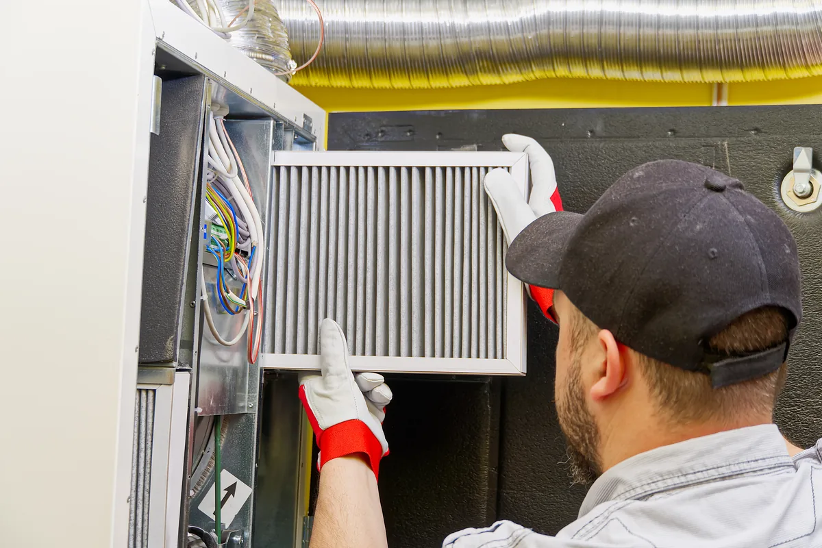 Technician servicing an indoor air handler