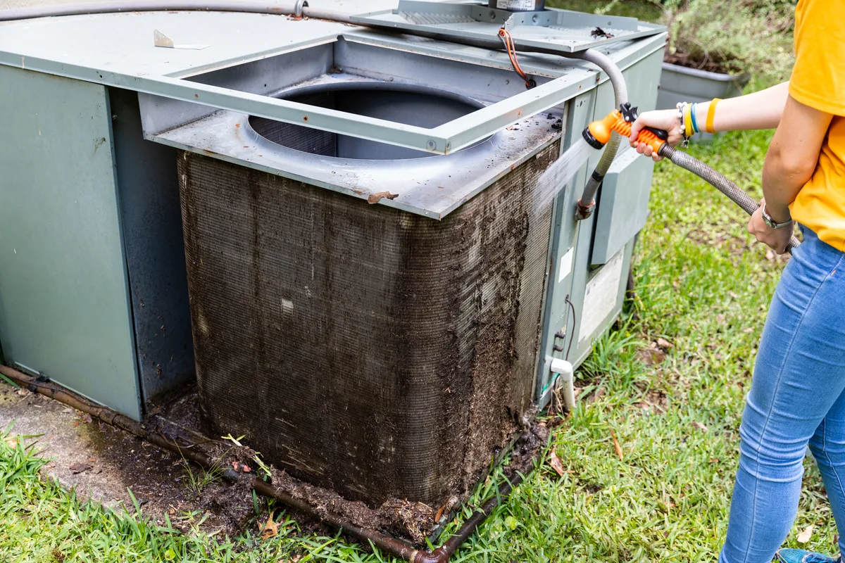 Aging outdoor condensing unit being assessed for replacement