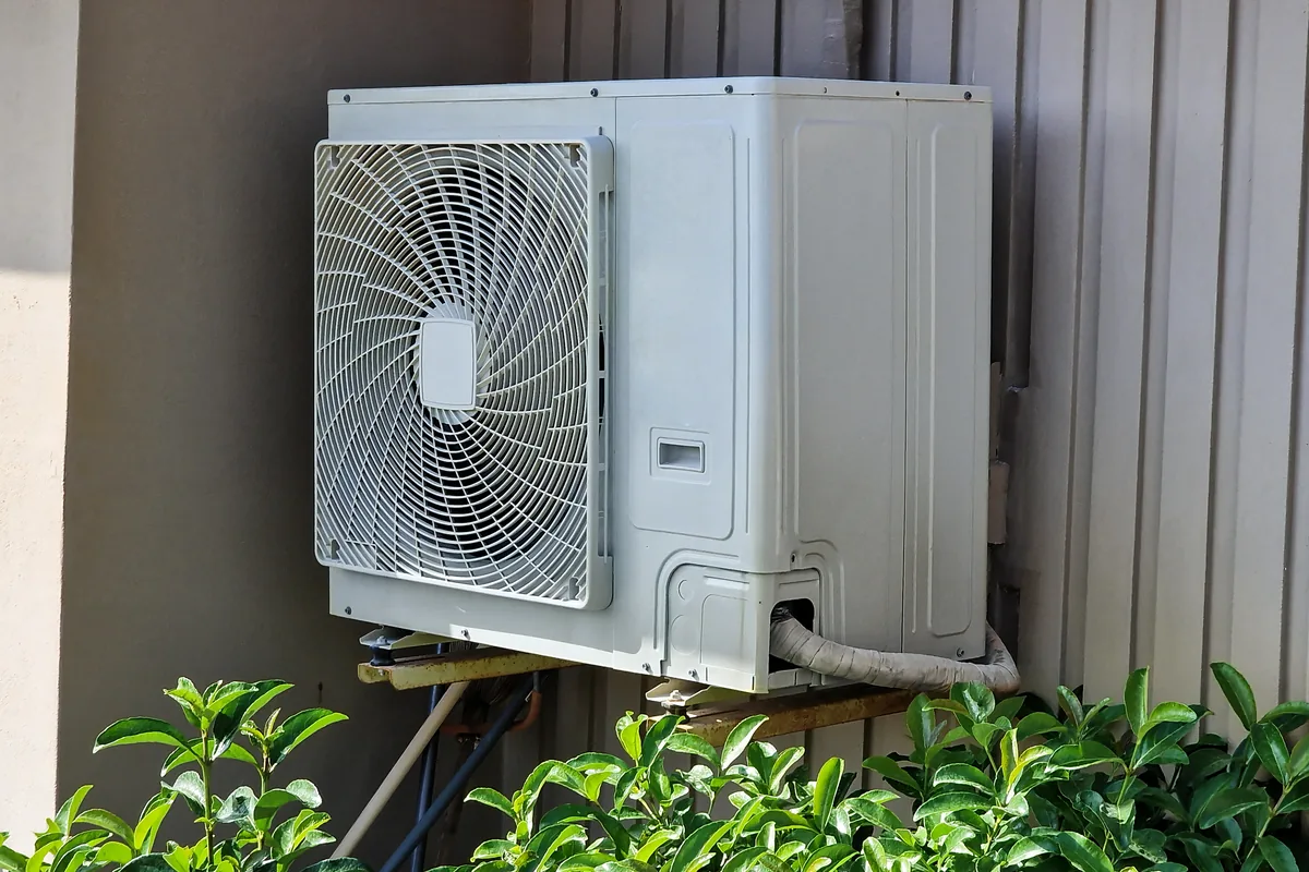 Ductless mini-split condenser mounted outside a home
