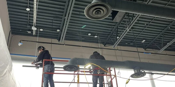 Aviation Mechanical crew installing commercial rooftop ductwork in Saskatoon